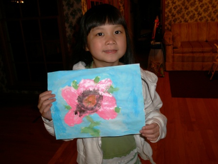 Kasen showing one of her paintings